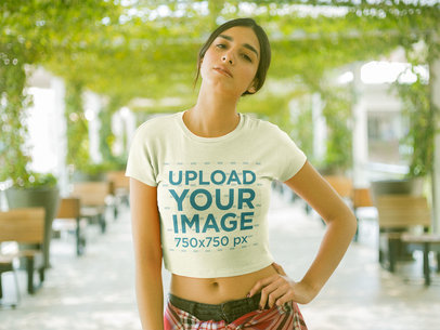Woman Wearing a Round Neck Tee Mockup at a Hall with Plants