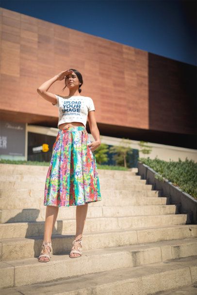 Woman Wearing a T-Shirt Mockup Standing Outside High School a19534