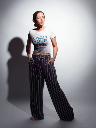 Light on a Woman Wearing a T-Shirt Template Standing in a White Room