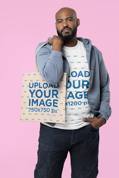 T-Shirt Mockup of a Serious Bearded Man Carrying a Tote Bag on His Shoulder