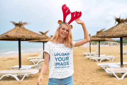 Xmas-Themed Mockup of a Teenage Girl Wearing a T-Shirt and a Reindeer Ears Headband
