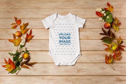 Thanksgiving Mockup Featuring a Onesie Placed on a Wooden Surface m19743 r-el2