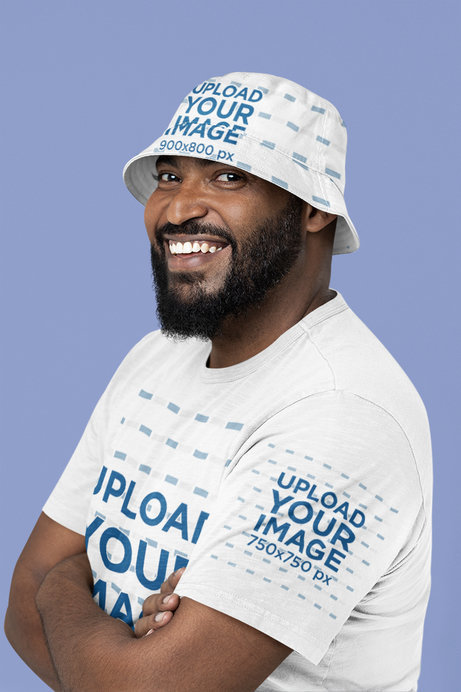 Bucket Hat and Tee Mockup Featuring a Happy Bearded Man Posing at a Studio