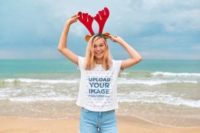 Heathered T-Shirt Mockup Featuring a Happy Teenager Girl With Reindeer Ears at the Beach