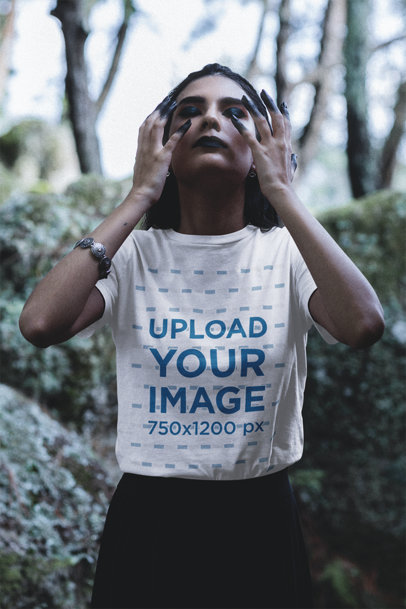 Bella Canvas T-Shirt Featuring a Woman With Dark Eye Makeup Posing in a Wicca Setting