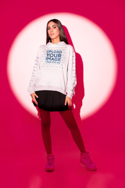 Pullover Hoodie Mockup of a Woman with Long Hair Standing in a Spotlight