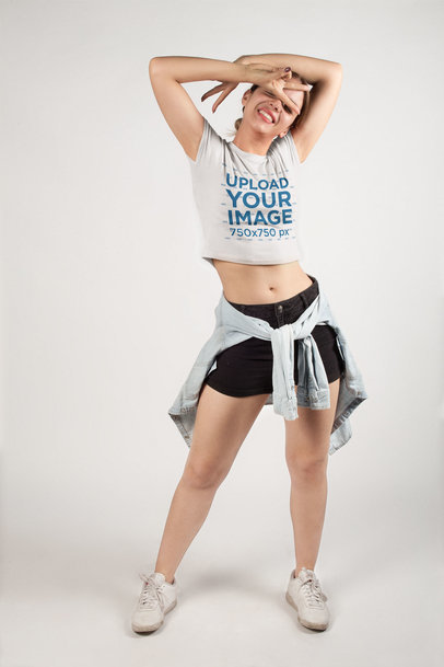 Blonde Woman Posing Wearing a Crop Top Tee Mockup in a White Room