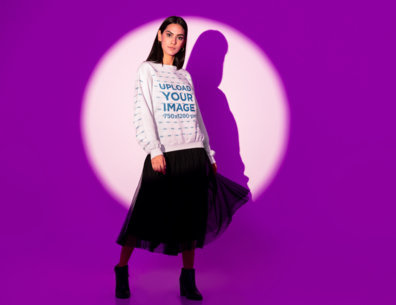 Sweatshirt Mockup Featuring a Woman Posing in a Spotlight