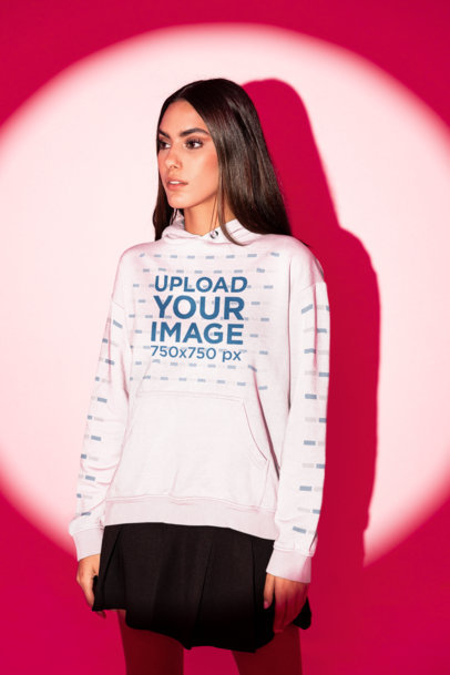 Hoodie and Sleeve Mockup Featuring a Woman Posing in a Red Light Studio