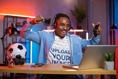 Round-Neck Tee Mockup Featuring a Happy Man Playing Virtual Soccer Games at Home m21381 r-el2