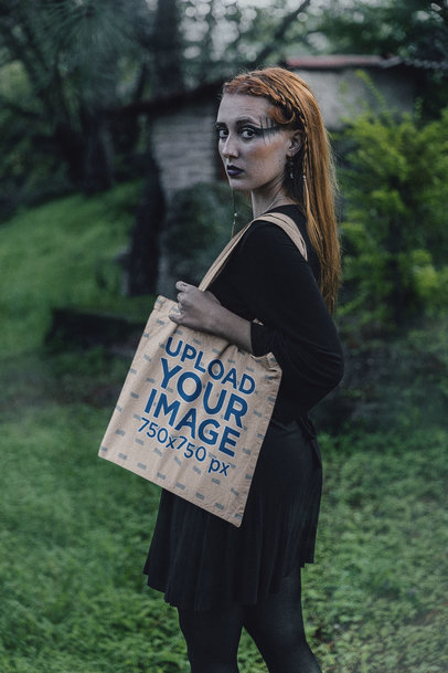 Mockup of a Woman Carrying a Tote Bag in a Wicca-Themed Forest Set