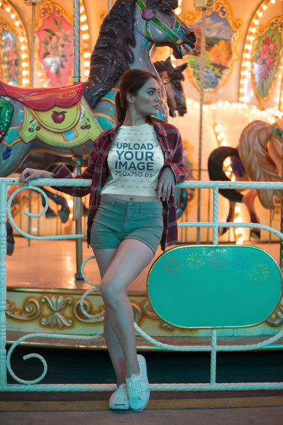Pretty Woman Wearing a Crop Top T-Shirt Mockup Against a Carousel