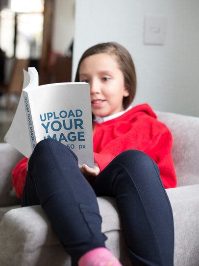 Girl Reading a Book Mockup Relaxing on her Sofa