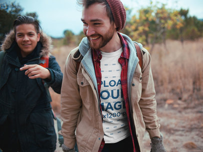 Man Wearing a T-Shirt Mockup While Trekking with his Friends