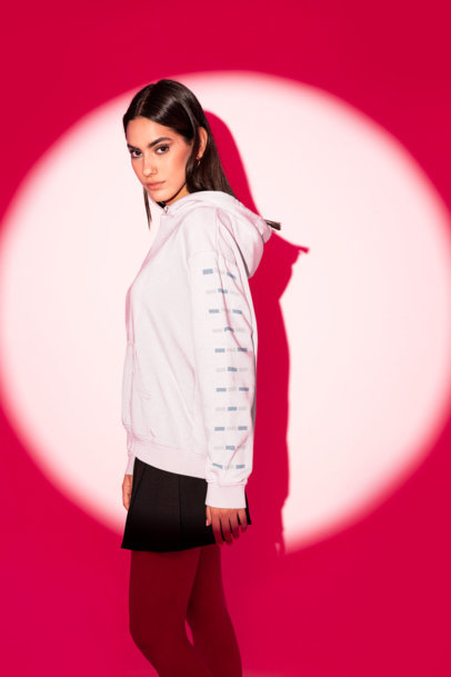 Mockup of a Woman Posing in a Pullover Hoodie with a Customizable Sleeve