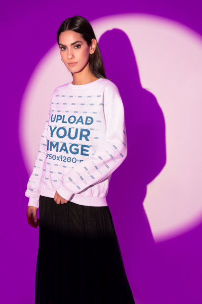 Sweatshirt Mockup of a Fashionable Woman Posing at a Studio With a Purple Lighting