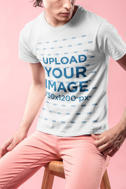 Closeup Mockup of a T-Shirt Being Worn by a Man in a Pink Room