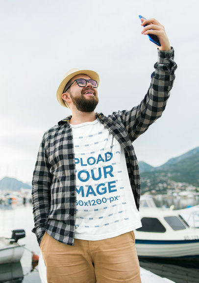 Round-Neck T-Shirt Mockup Featuring a Joyful Bearded Man Taking a Selfie