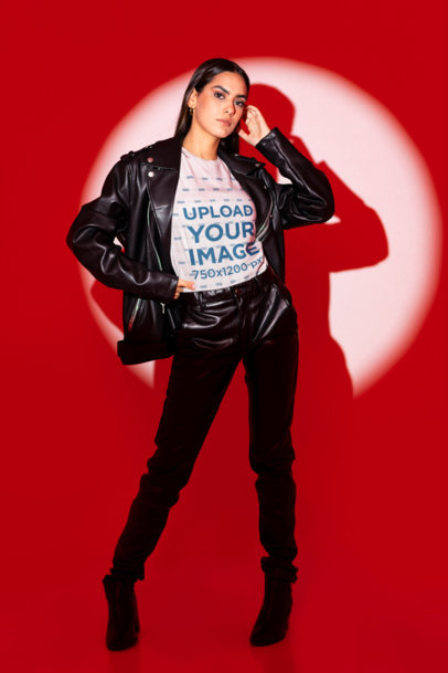 Bella Canvas T-Shirt Mockup of a Woman with Leather Garments Standing in a Spotlight