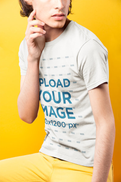 Cropped Face Dude Wearing a T-Shirt Mockup Against a Yellow Background