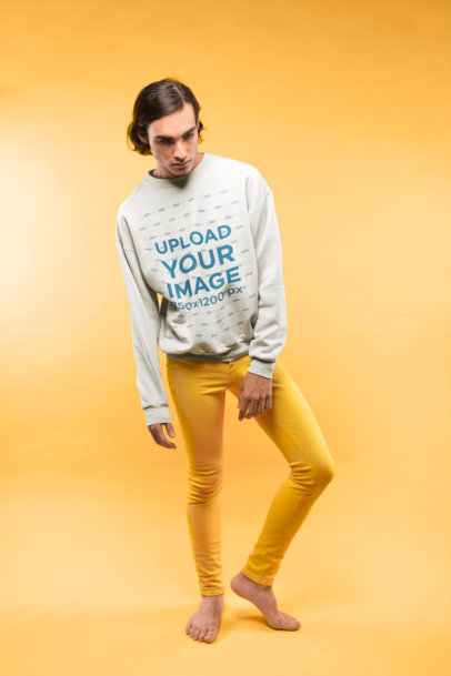 Barefoot Man Wearing a Crewneck Sweatshirt Mockup and Yellow Pants at a Studio a19676