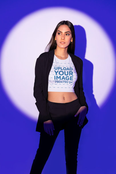 Bella Canvas Crop Top Mockup of a Serious Brunette Woman Posing Against a Purple Spotlight