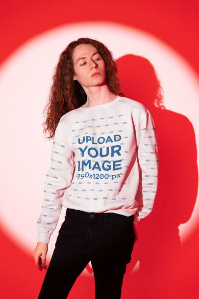 Sweatshirt Mockup Featuring a Man Posing at a Studio With a Red Lighting