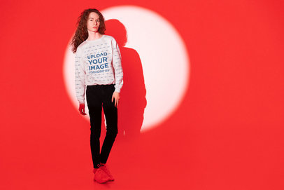 Sweatshirt Mockup of a Serious Long-Haired Man Posing Against a Red Lighting