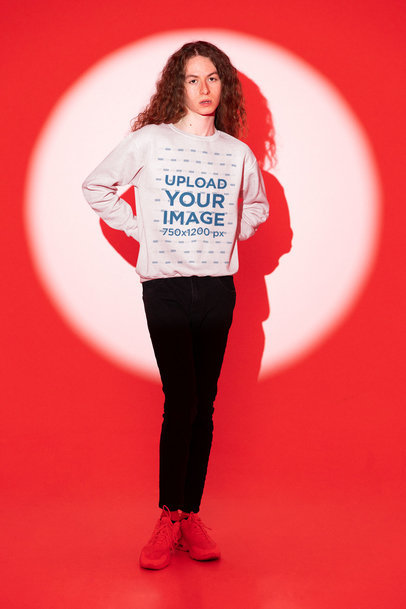 Sweatshirt Mockup of a Long-Haired Man Standing in the Spotlight at a Studio