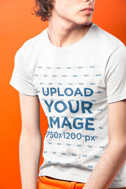 Closeup of a Man Wearing a Round Neck Tee Mockup in an Orange Room