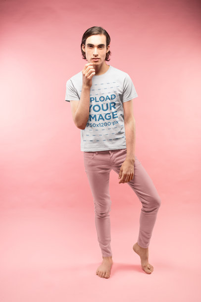 Man Posing Wearing a Tshirt Mockup in a Pink Room