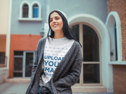 Happy Woman Wearing a Round Neck Sweater Mockup Outside her House in Winter