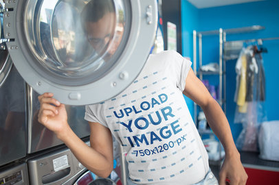 Man Hiding Behind a Laundromat Door Wearing a T-Shirt Mockup a19697
