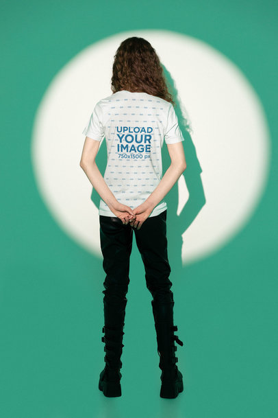 Back-View Bella Canvas Tee Mockup of a Curly-Haired Man in a Studio With a Green Light