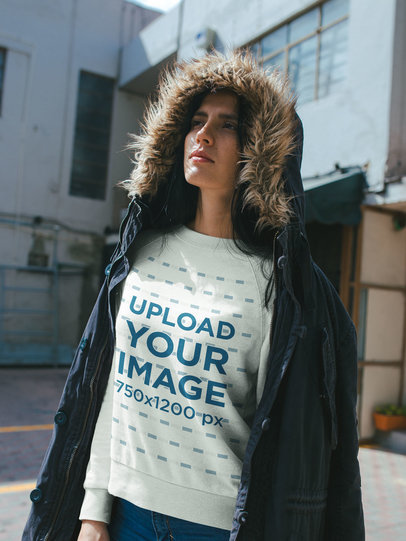 Winter Shot of a Woman Wearing a Crewneck Sweater Mockup at an Alley 