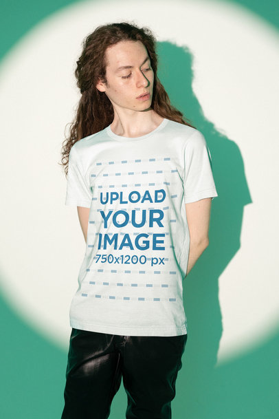 Bella Canvas Tee Mockup Featuring a Man Posing Against a Green Studio Light