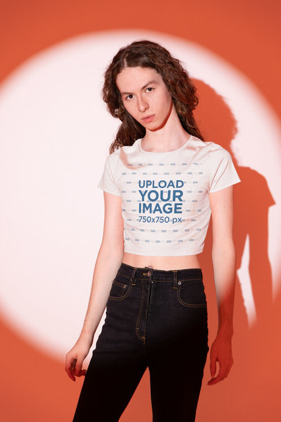 Mockup of a Long-Haired Man Wearing a Bella Canvas Crop Top at a Studio