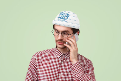 Beanie Mockup Featuring a Serious Man Using a Phone in a Studio