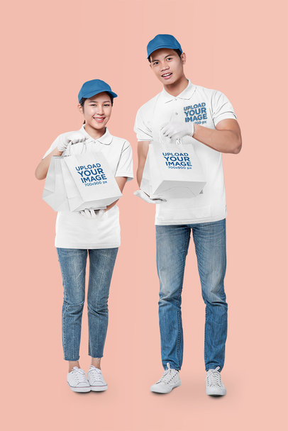 Mockup of Two Workers in Polo Shirts Holding Paper Bags