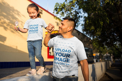 Man with Daughter Walking Wearing T-Shirts Mockup at the Park