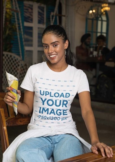 Gildan T-Shirt Mockup of a Smiling Woman Posing With an Indian Snack
