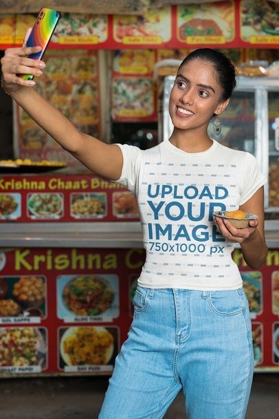 Gildan Tee Mockup Featuring a Happy Woman Taking a Selfie Near an Indian Foodtruck