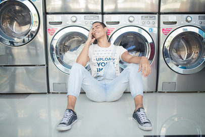 Happy Dude Wearing a T-Shirt Mockup Sitting Against Washing Machines a19701