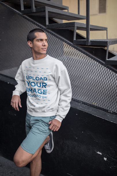 Man Leaning Against Stairways Wearing a Sweatshirt Mockup a19707