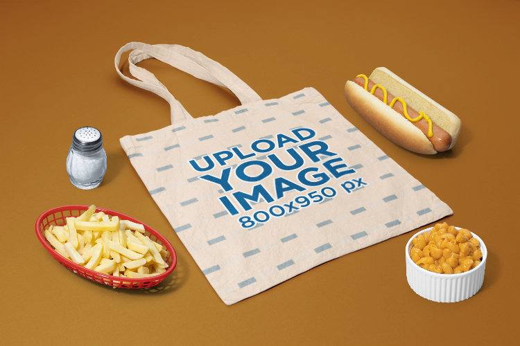 Mockup of a Sublimated Tote Bag Surrounded by Fast Food Items