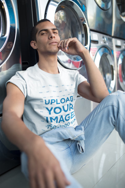 Man Wearing a T-Shirt Mockup Resting at a Laundry