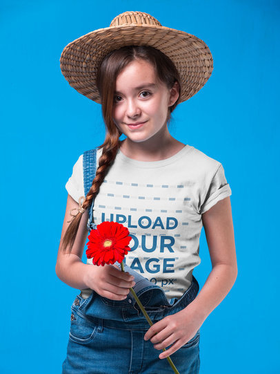 Country Girl Wearing a T-Shirt Mockup Holding a Red Sunflower