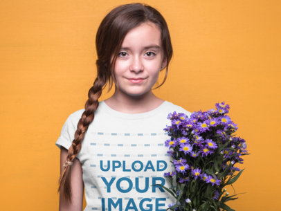 Girl Wearing a T-Shirt Mockup Against an Orange Wall