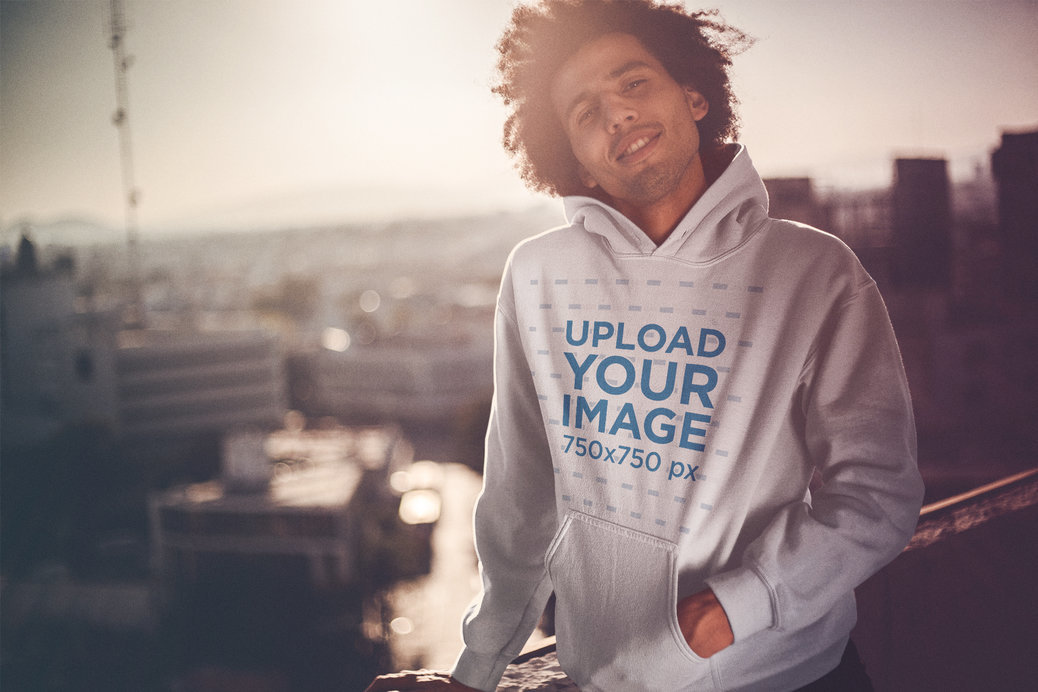 Mockup of a Dude with an Afro Wearing a Pullover Hoodie During the Sunset