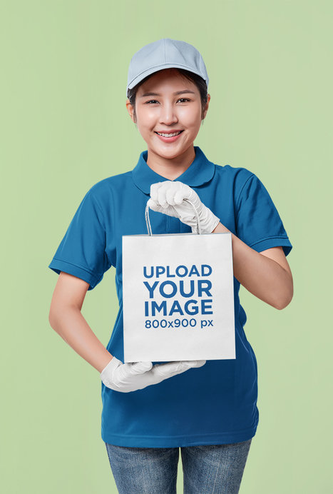 Mockup of a Smiling Woman Holding a Paper Bag